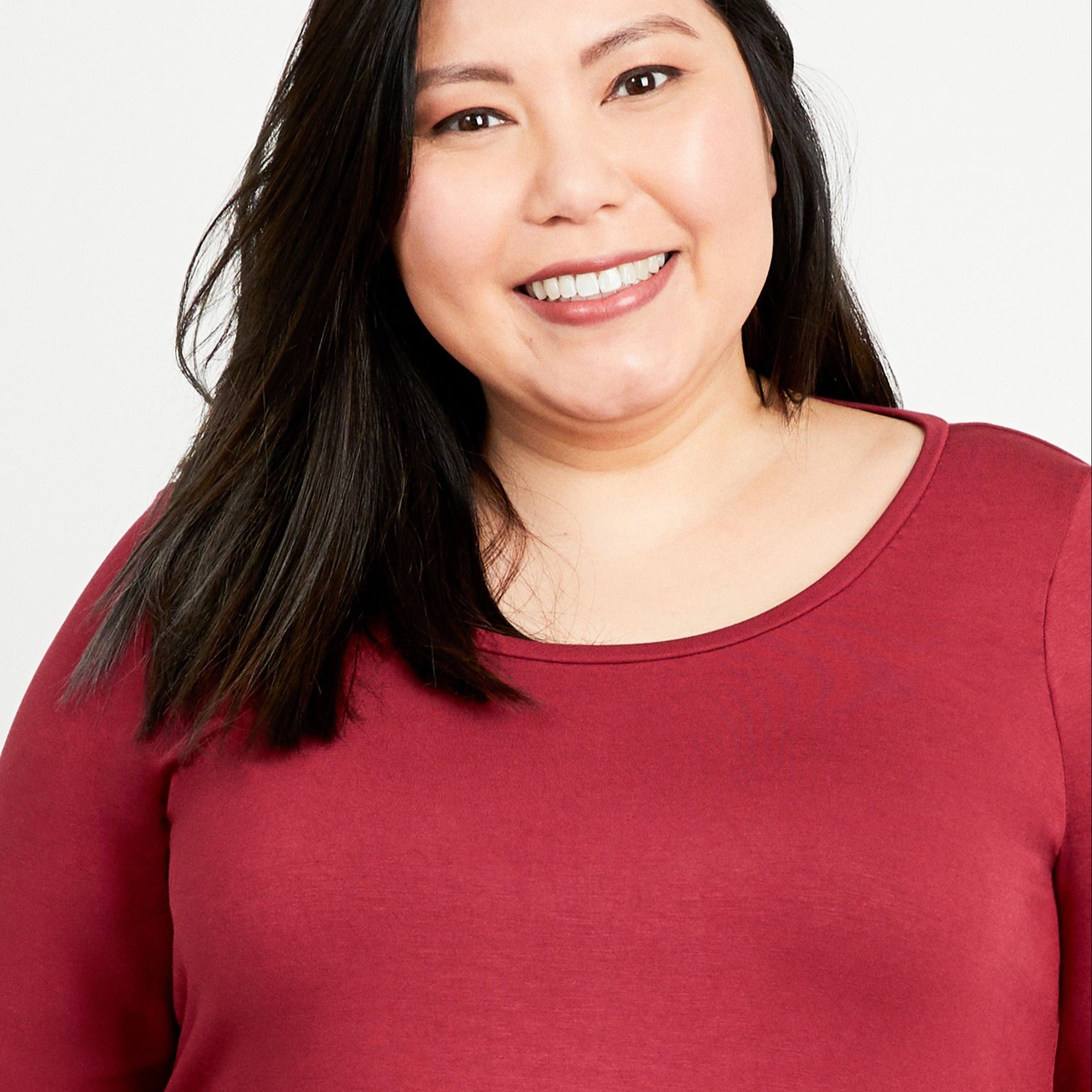 Woman wearing a red shirt against a white background. This t-shirt is the Concord T-Shirt sewing pattern from Cashmerette.