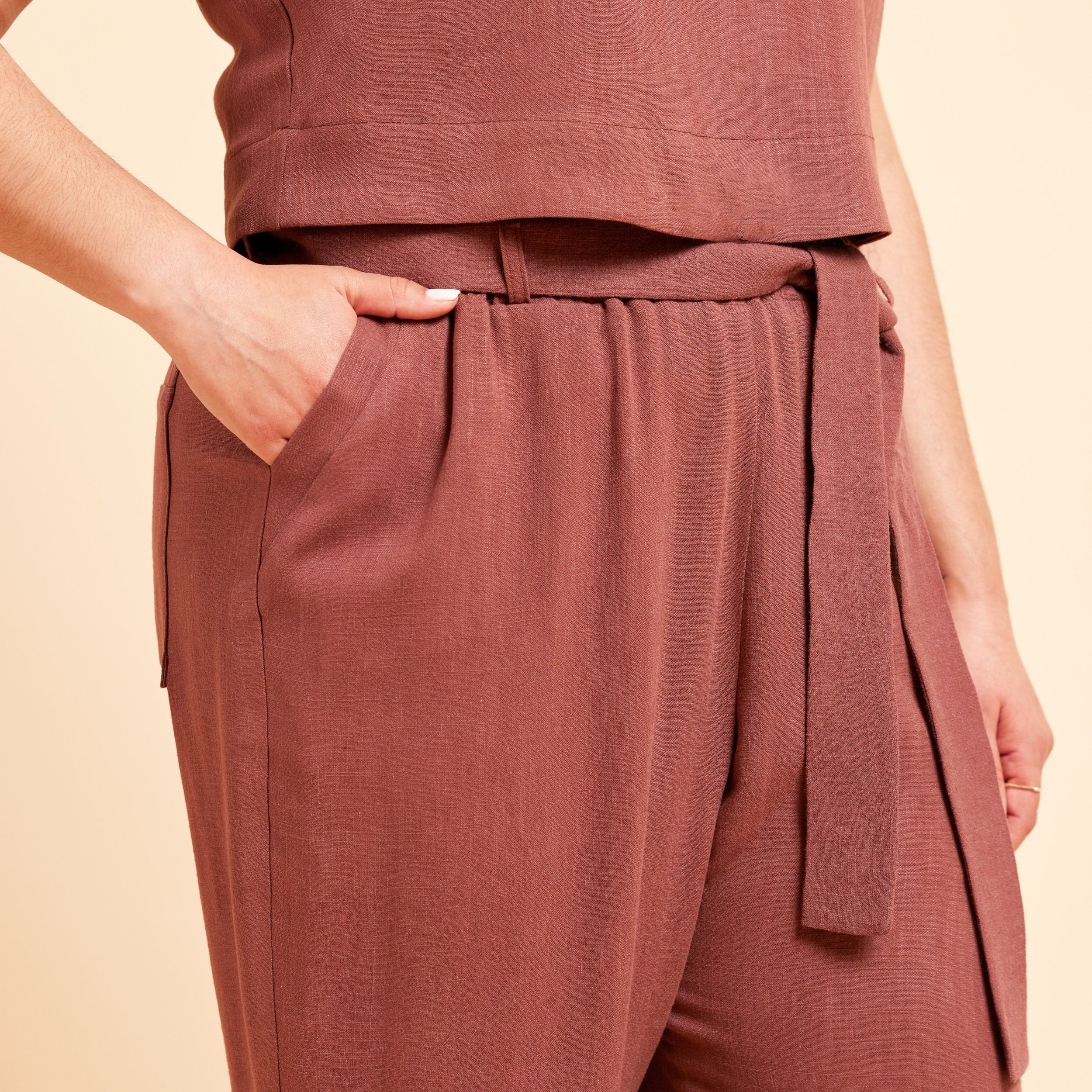 Brown sleeveless top and pants set on a beige background. These pants are the Everett Pants & Shorts sewing pattern from Cashmerette.
