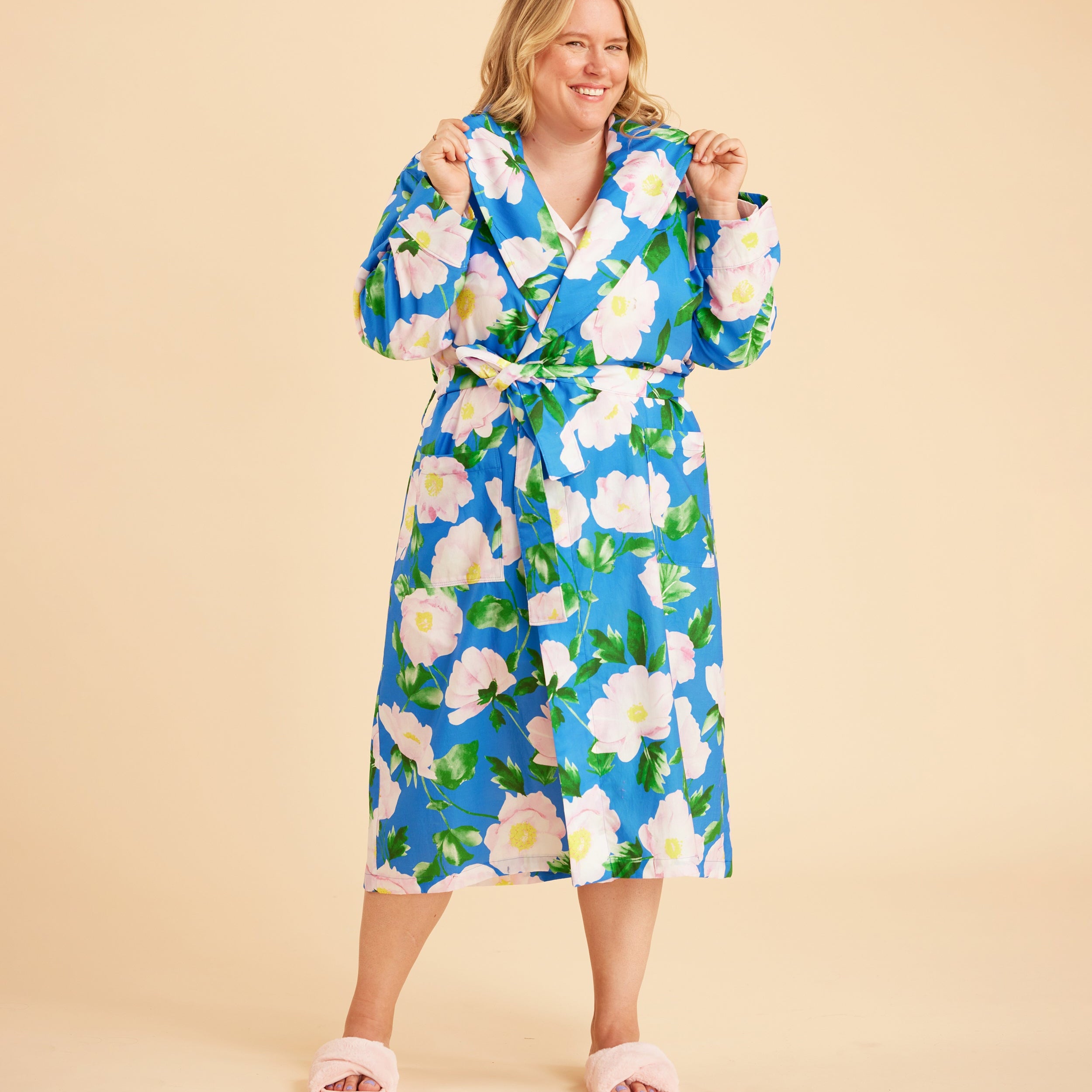 Woman wearing a blue floral robe against a beige background. This is the Fiske Sleepwear Set sewing pattern from Cashmerette.