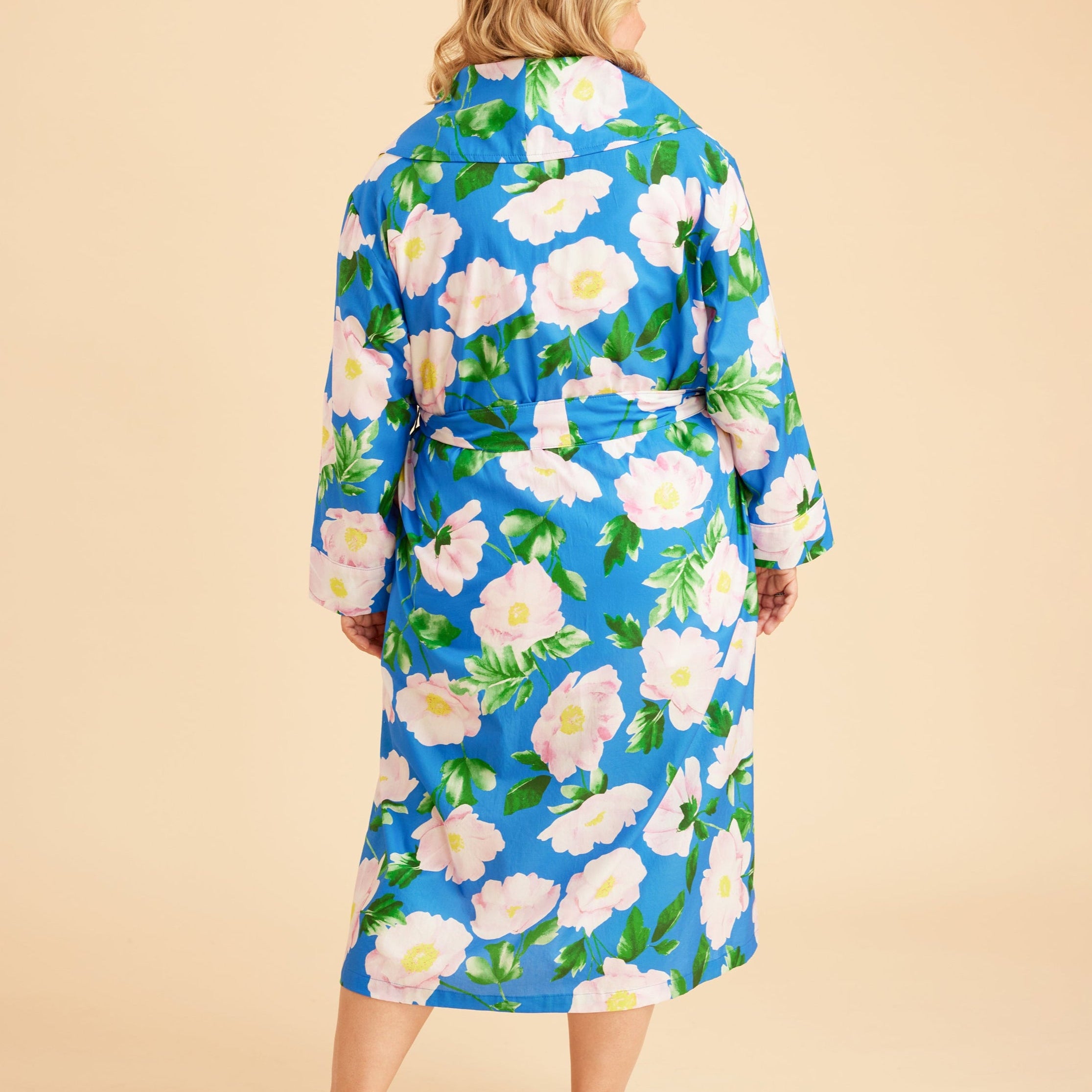 Woman wearing a blue floral robe against a beige background. This is the Fiske Sleepwear Set sewing pattern from Cashmerette.