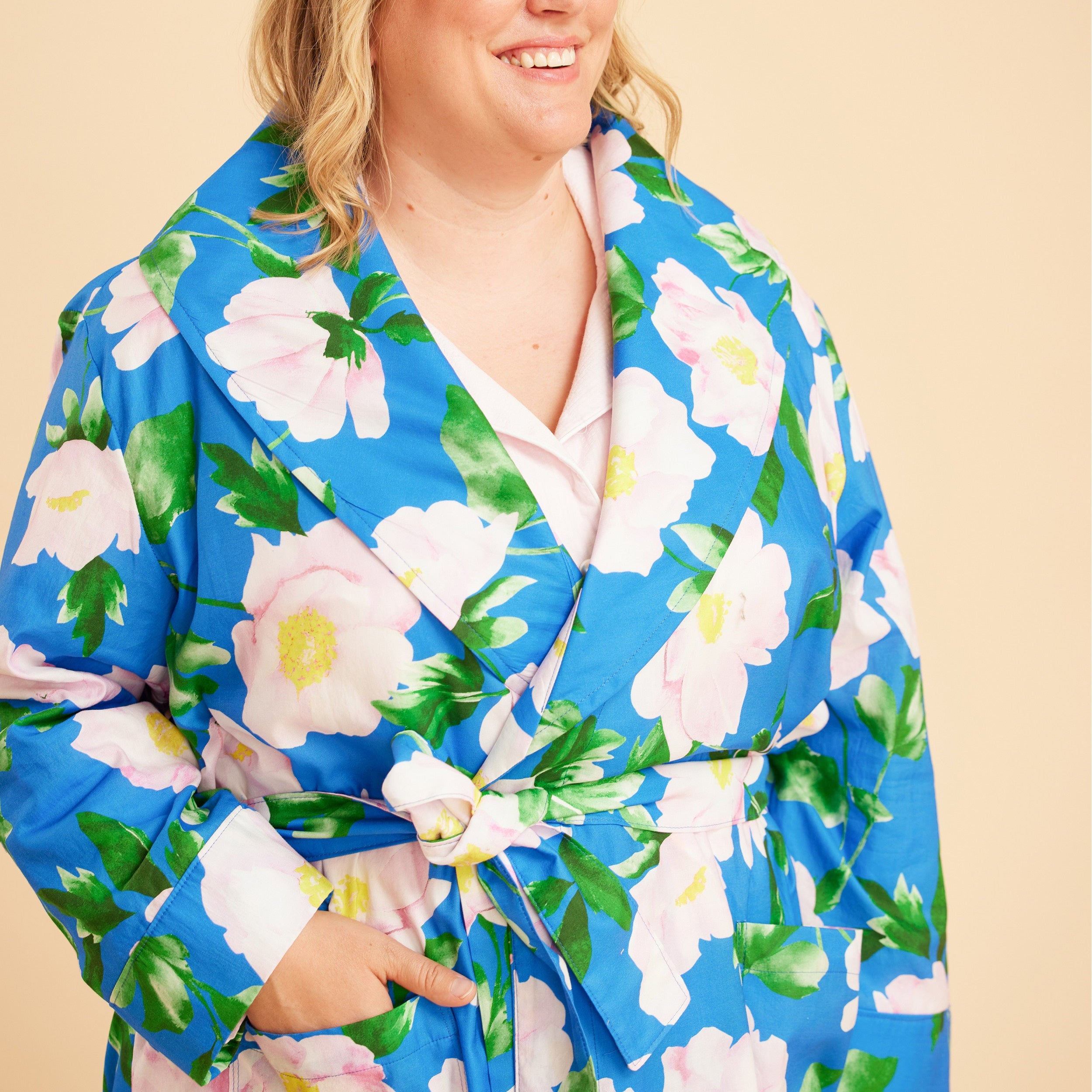 Woman wearing a blue floral robe against a beige background. This is the Fiske Sleepwear Set sewing pattern from Cashmerette.
