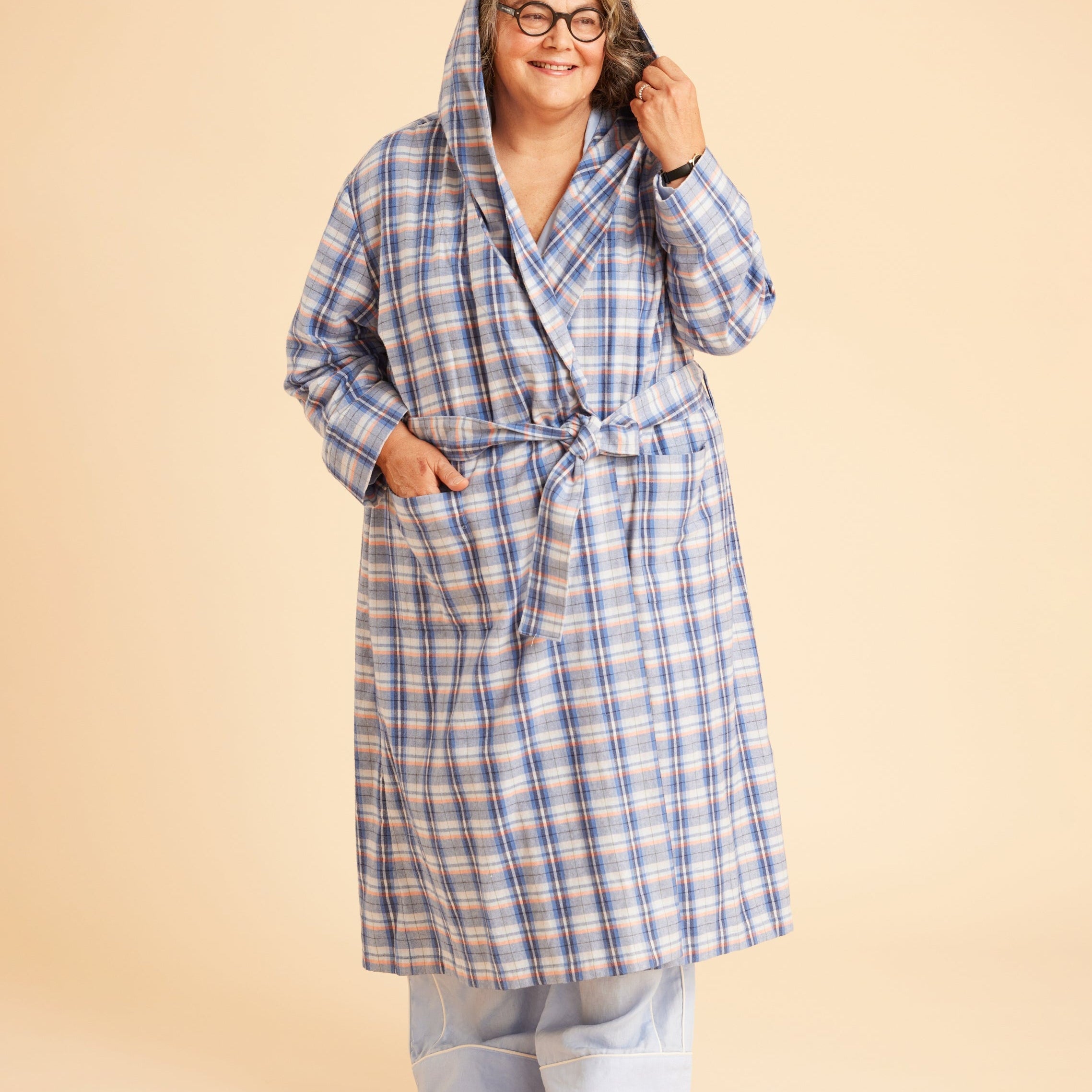 Person wearing a blue plaid robe on a beige background. This is the Fiske Sleepwear Set sewing pattern from Cashmerette.