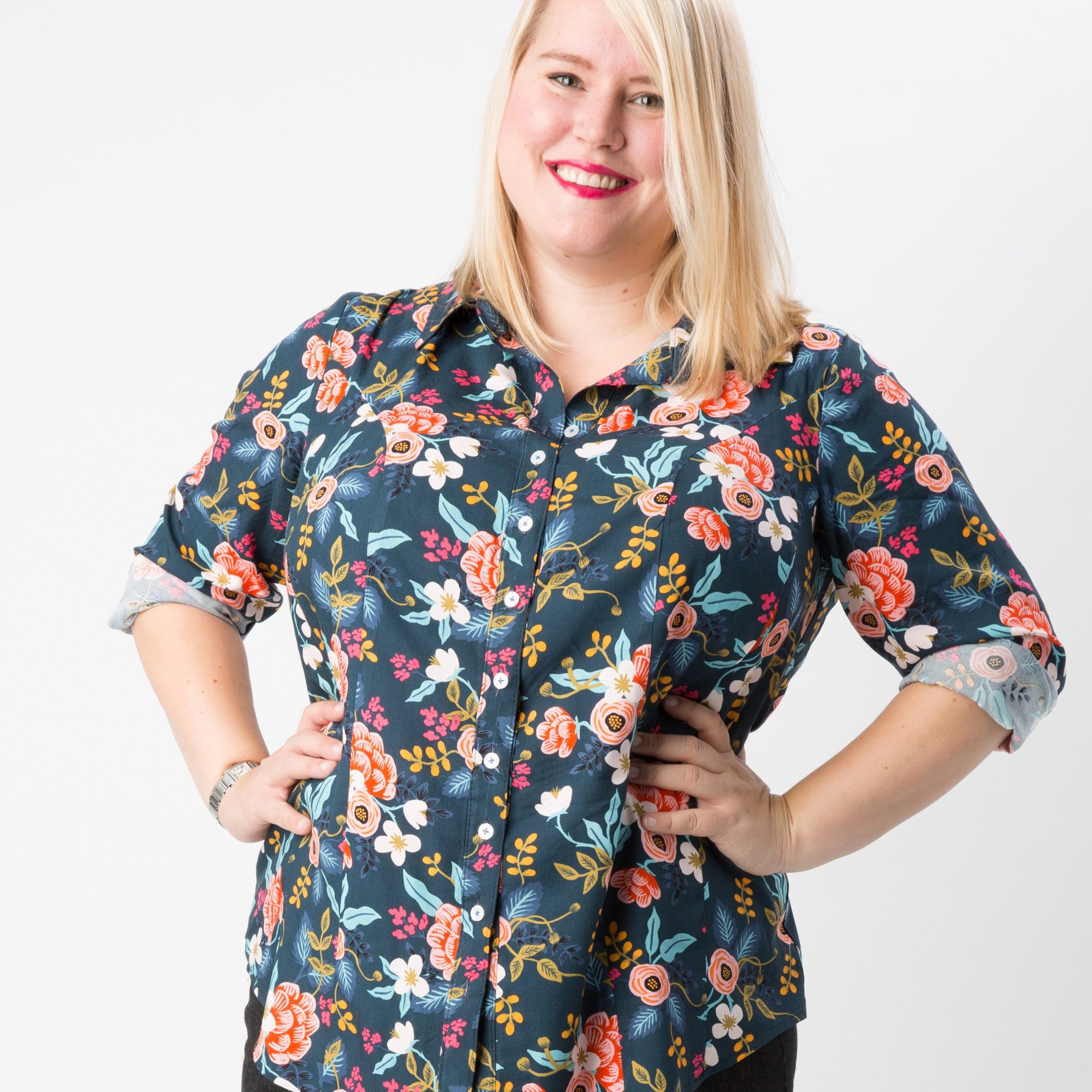 Woman wearing a floral patterned shirt on a white background. This button-up shirt is the Harrison Shirt sewing pattern from Cashmerette.