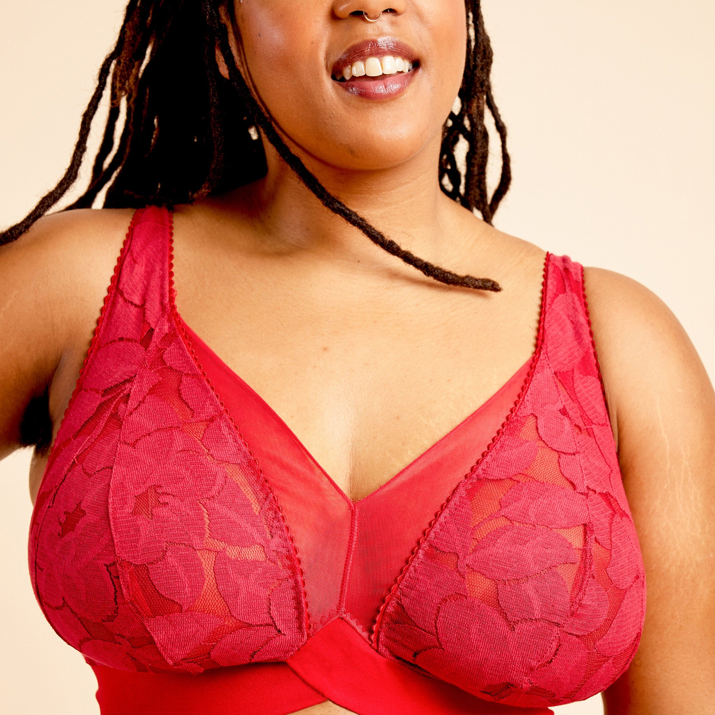 Woman wearing a red lace bra against a beige background. This bralette is the Loftus Bralette sewing pattern from Cashmerette.