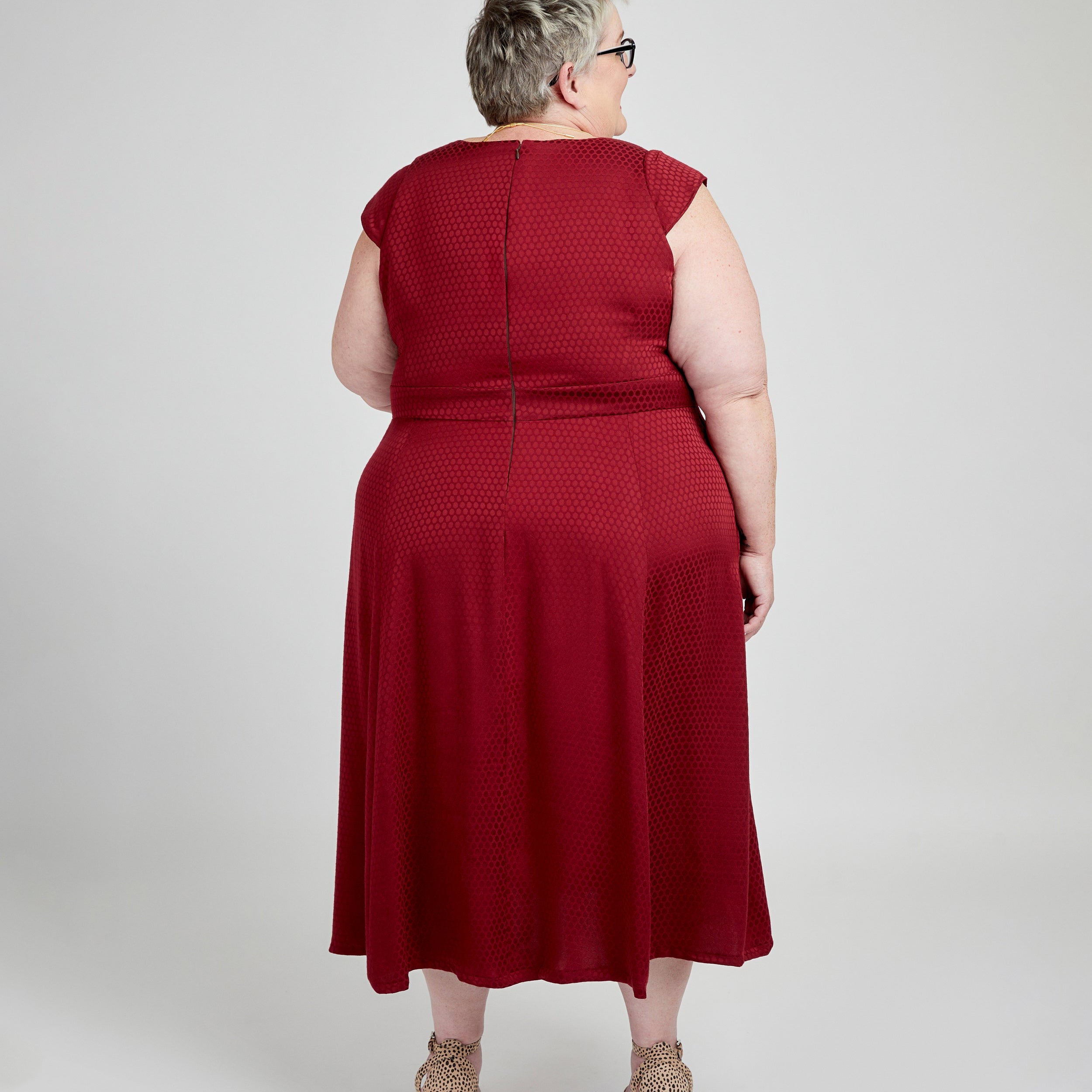 Person wearing a red dress on a white background. This dress is the Upton Dress & Skirt sewing pattern from Cashmerette.