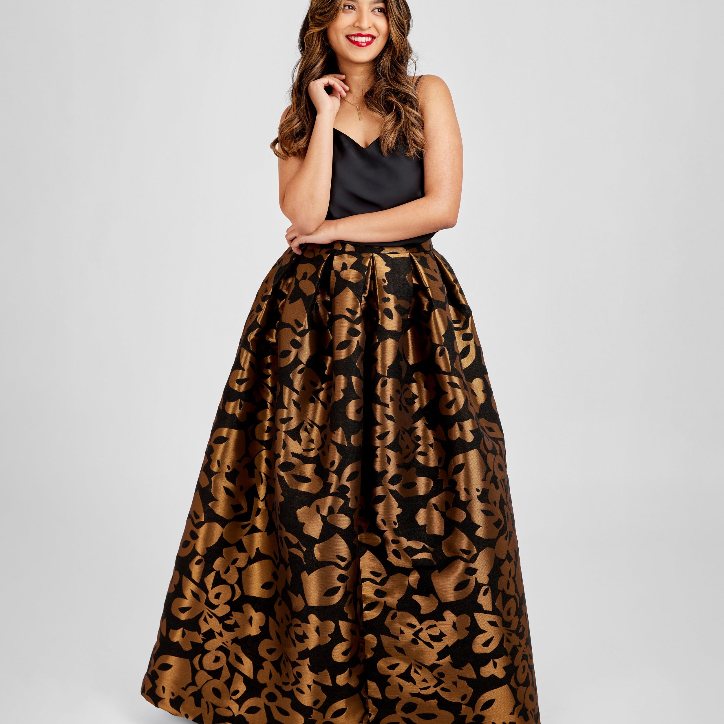 Woman wearing a black top and leopard print skirt on a white background. This skirt is the Upton Dress & Skirt sewing pattern from Cashmerette.