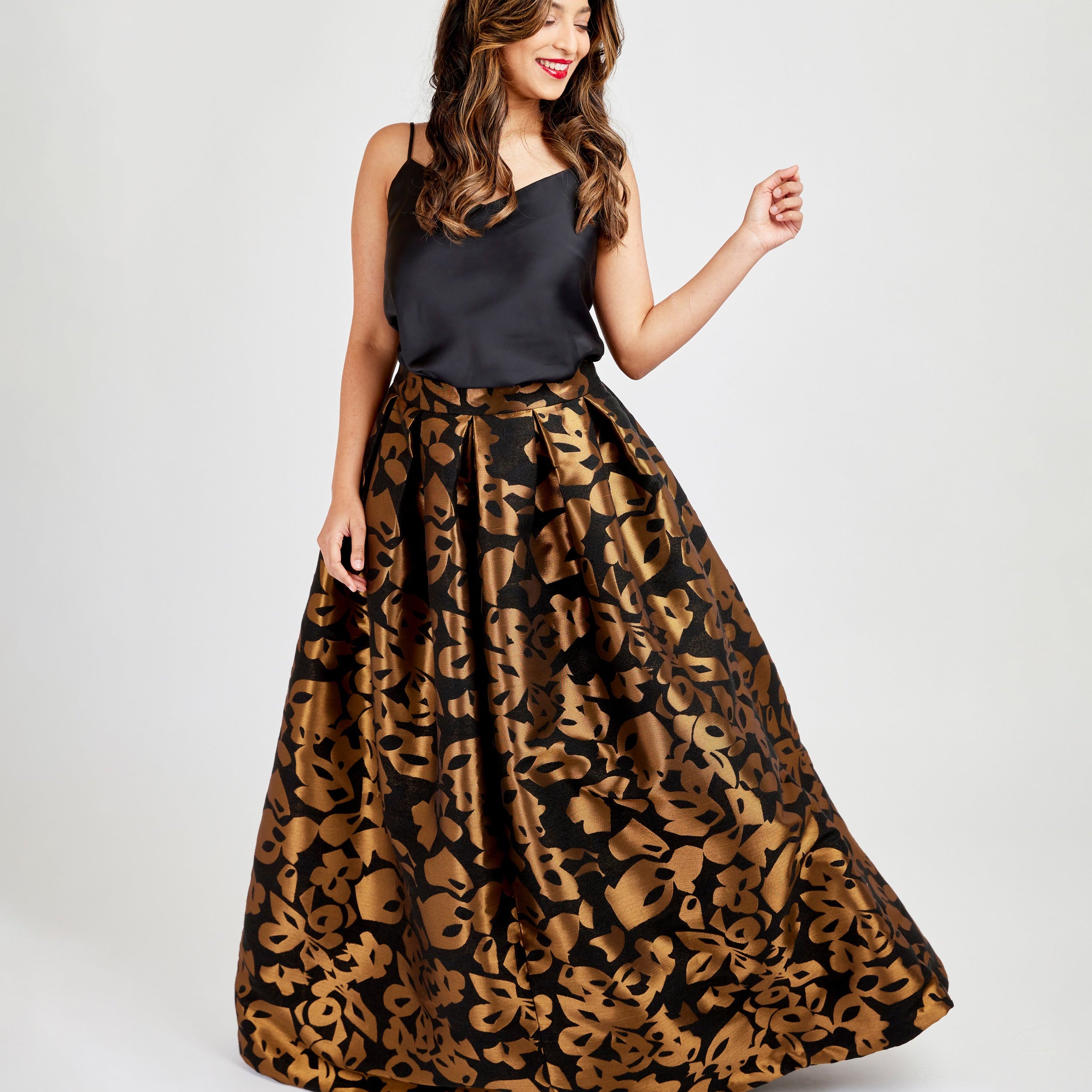 Woman wearing a black top and leopard print skirt on a white background. This skirt is the Upton Dress & Skirt sewing pattern from Cashmerette.