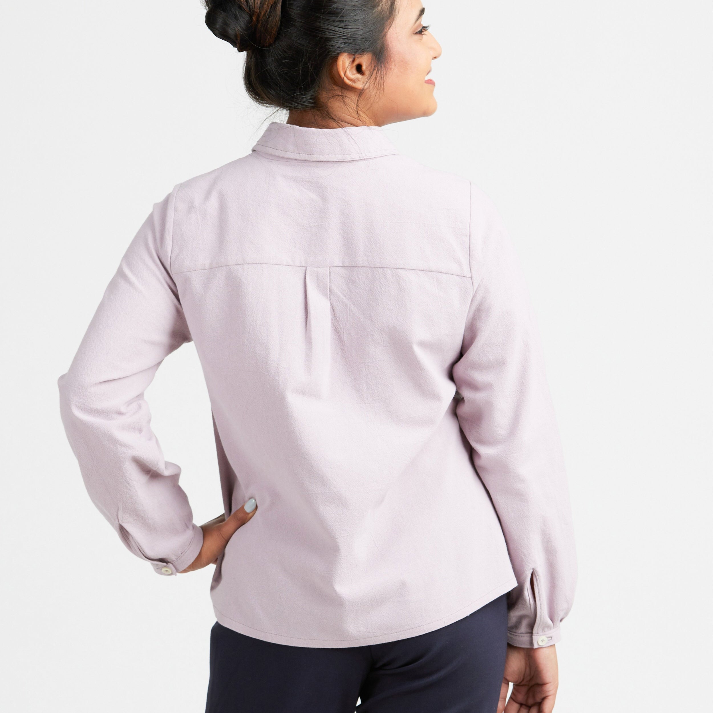 Woman wearing a light purple jacket on a white background. This top is the Vernon Shirt sewing pattern from Cashmerette.