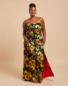 Woman wearing a strapless floral dress with a red lining on a beige background. This dress is the Ellington Strapless Dress sewing pattern from Cashmerette.