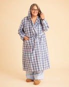 Person wearing a blue plaid robe on a beige background. This is the Fiske Sleepwear Set sewing pattern from Cashmerette.