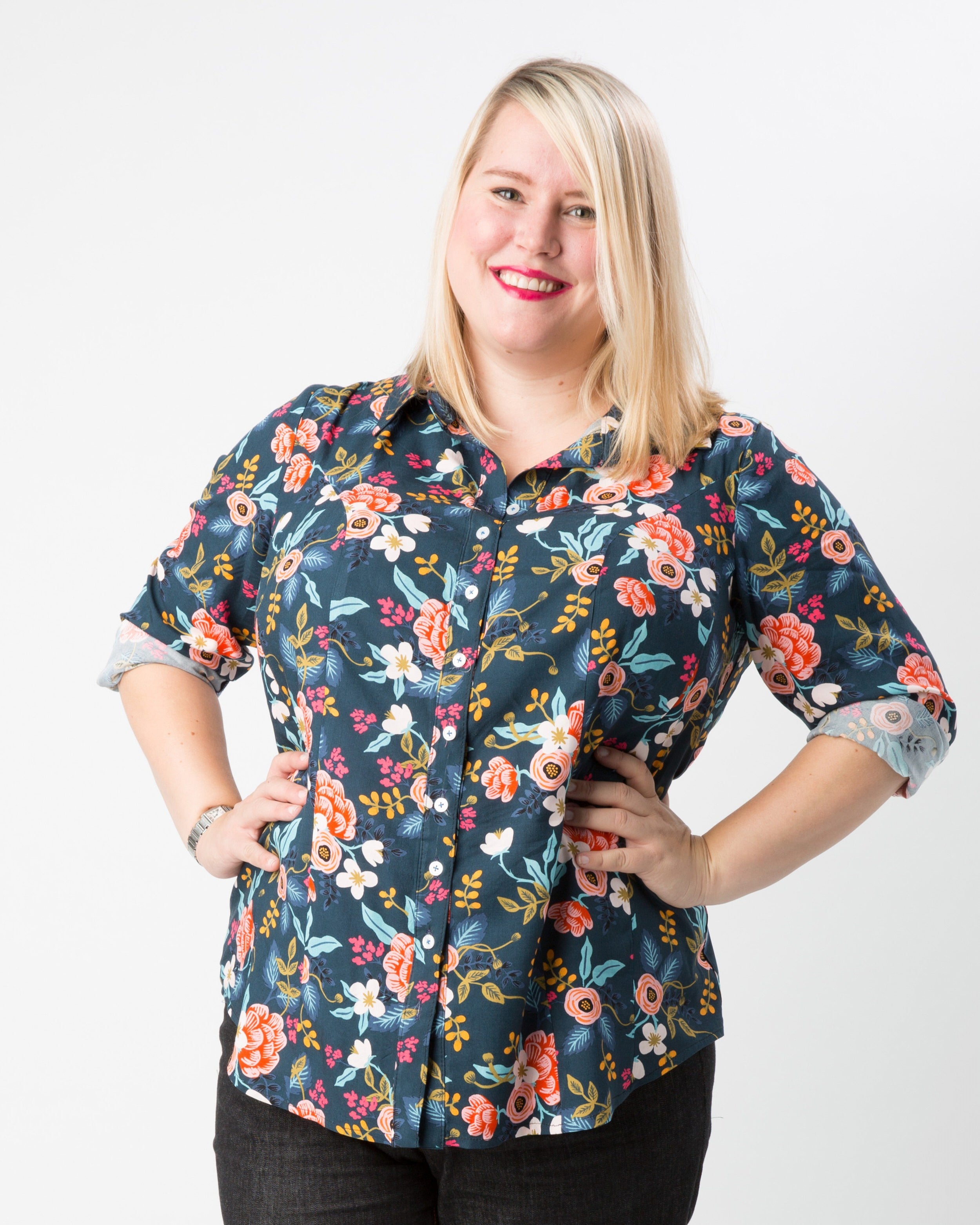 Woman wearing a floral patterned shirt on a white background. This button-up shirt is the Harrison Shirt sewing pattern from Cashmerette.