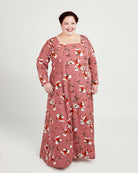 Woman wearing a floral dress on a white background. This dress is the Upton Dress & Skirt sewing pattern from Cashmerette.