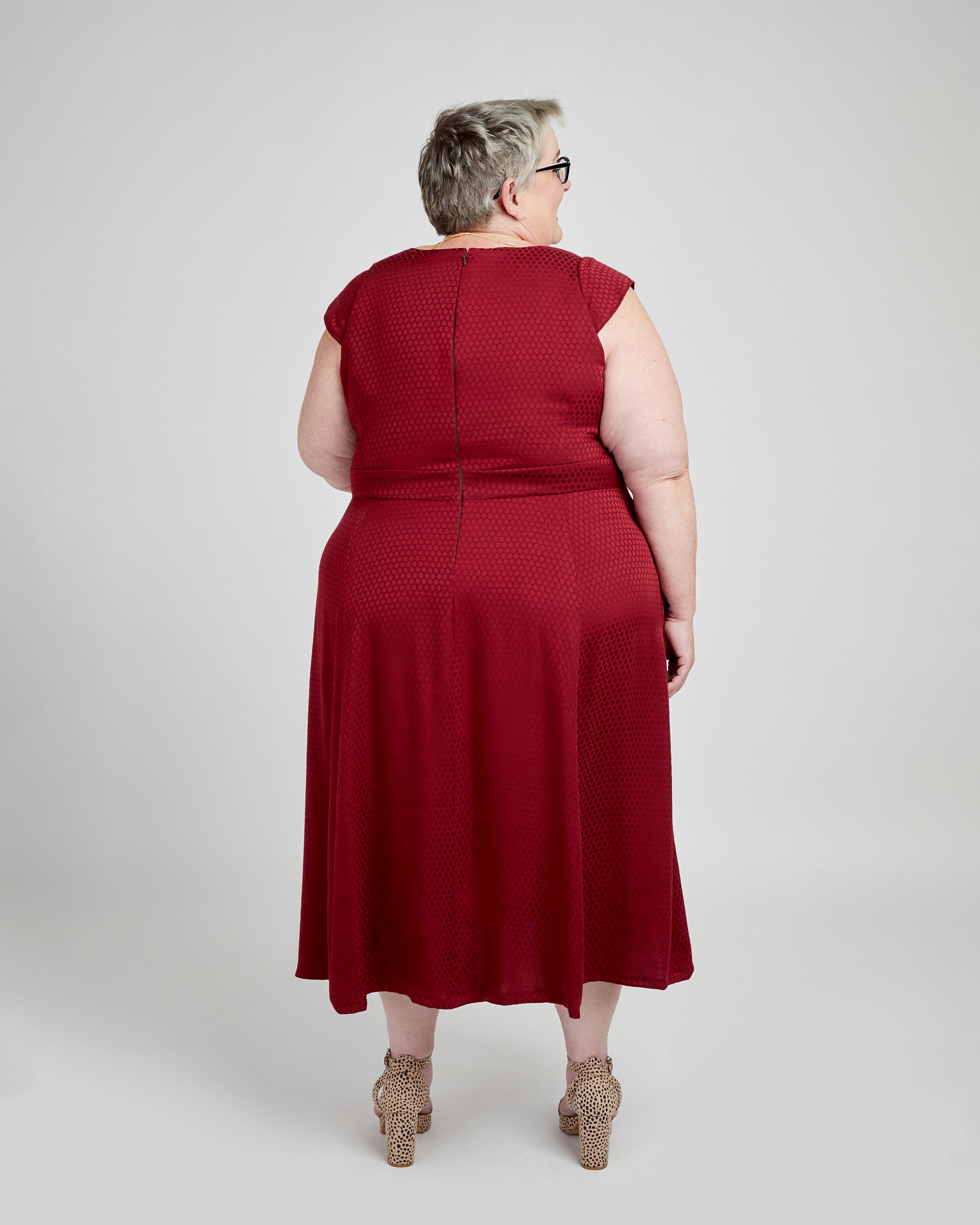Person wearing a red dress on a white background. This dress is the Upton Dress & Skirt sewing pattern from Cashmerette.