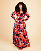 Woman wearing a colorful patterned dress on a beige background. This dress is the Upton Dress & Skirt sewing pattern from Cashmerette.